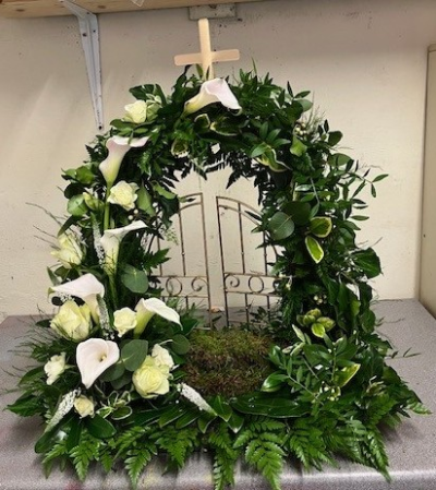 Gates of Heaven - A personal tribute with a mixed selection of foliage creating the arch and a pillar of Calla Lillies and Roses.