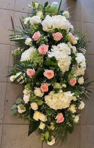 Rose and Hydrangea Casket Spray - A Casket spray of white Hydrangea and pink Roses with a selection of seasonal blooms.